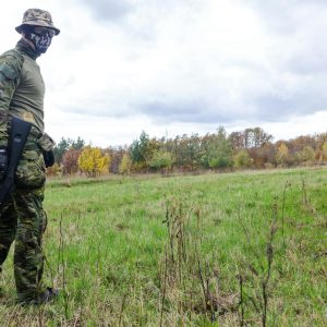Photo of Man Wearing Green Combat Uniform Holding Rifle